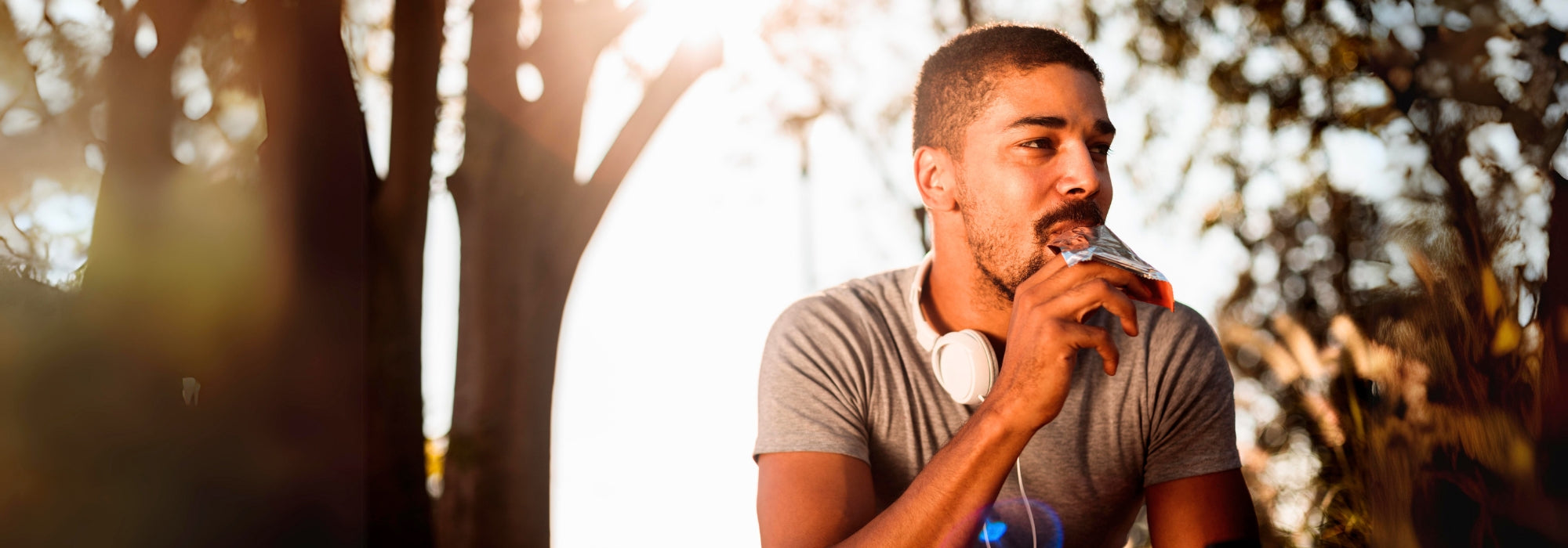 Young African American Man Resting Eating Protein Bar